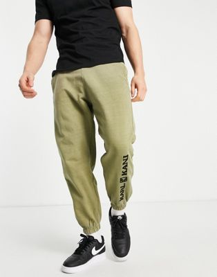Зеленые спортивные штаны с эффектом потертости в стиле ретро Karl Kani Karl Kani