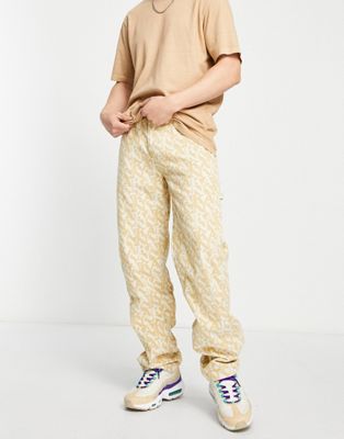 Вельветовые брюки в стиле ретро Karl Kani песочного цвета с логотипом по всей поверхности - часть комплекта Karl Kani