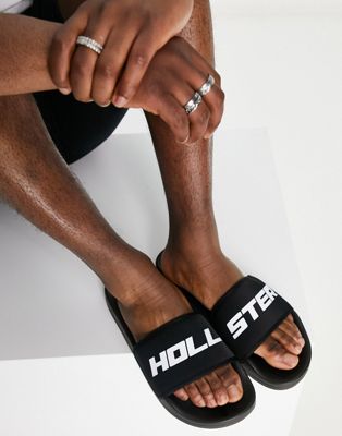 Черные шлепанцы Hollister со светоотражающим логотипом Hollister