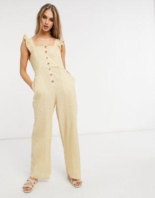Fashion Union Exclusive beach button closure jumpsuit with ruffle detail in mustard wave print Fashion Union