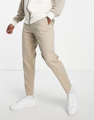 Элегантные брюки из смесового хлопка Selected Homme песочного цвета, узкого зауженного кроя и эластичной талией. Selected