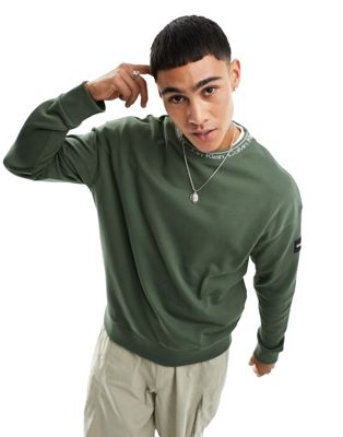 Calvin Klein running logo comfort sweatshirt in green Calvin Klein