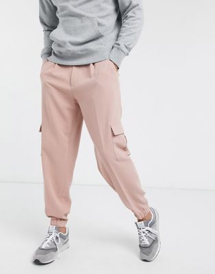 Розовые зауженные спортивные брюки оверсайз с карманом-карго ASOS DESIGN ASOS DESIGN