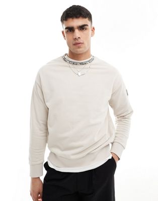 Calvin Klein running logo comfort sweatshirt in beige - exclusive to ASOS Calvin Klein