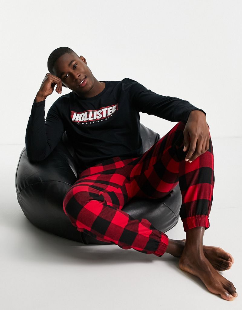 Комплект для отдыха Hollister: спортивные штаны и топ с длинными рукавами в красную/черную клетку с логотипом Hollister