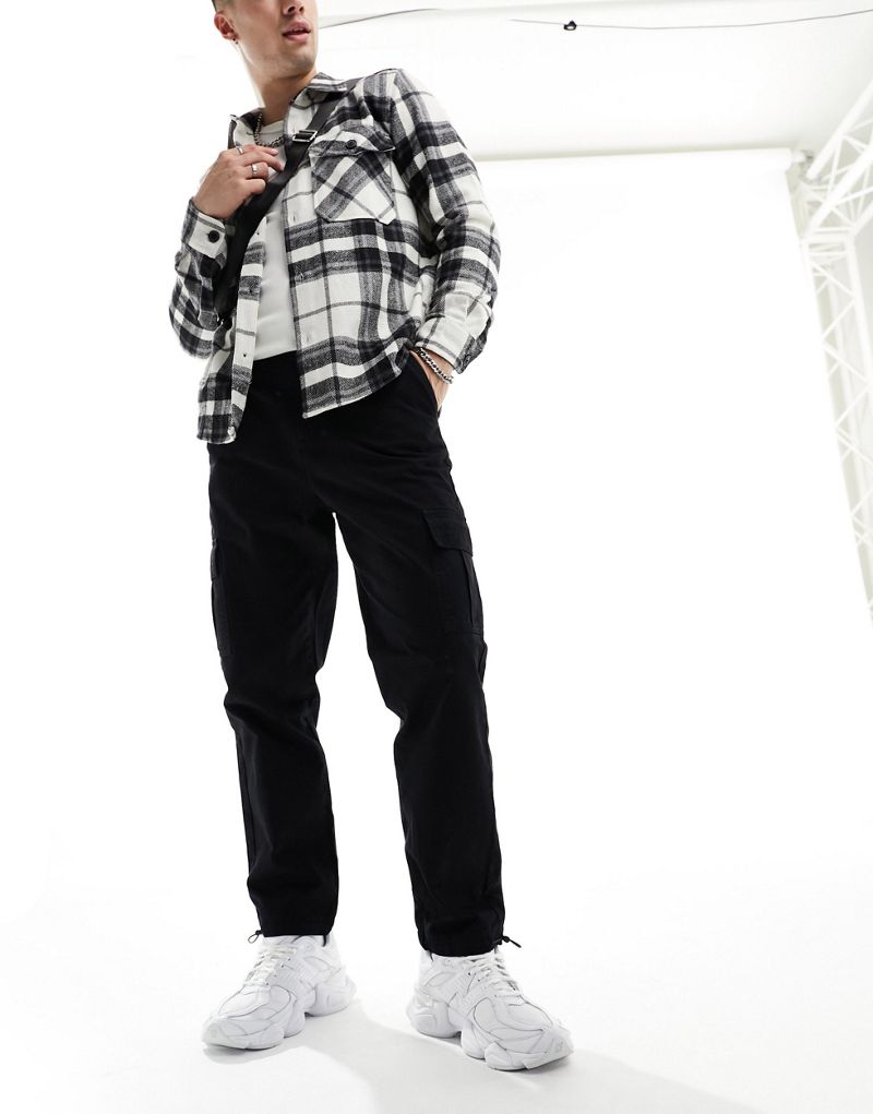 Another Influence relaxed fit tapered cargo pants with ankle toggle in black  Another Influence