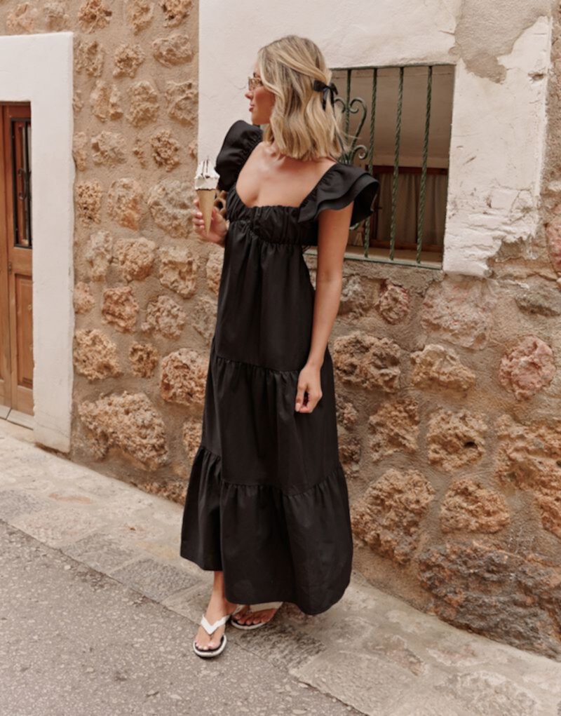 The Frolic x Lyds Butler escora frill detail tie back maxi tiered beach dress in black The Frolic