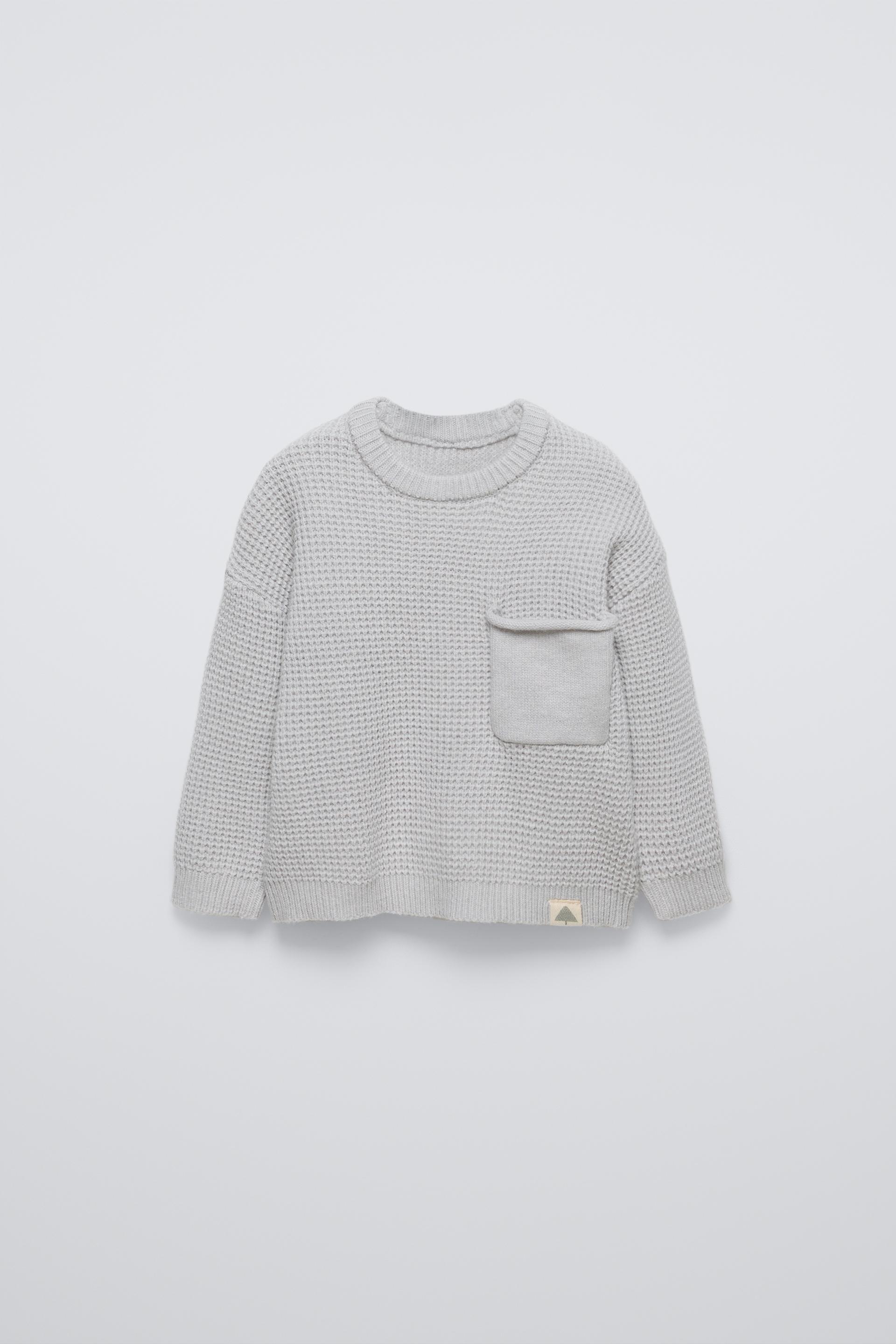 Sweater with round neck and long sleeves with cuffs. Back button closure. Patch pocket at chest. Label appliqué at hem. ZARA