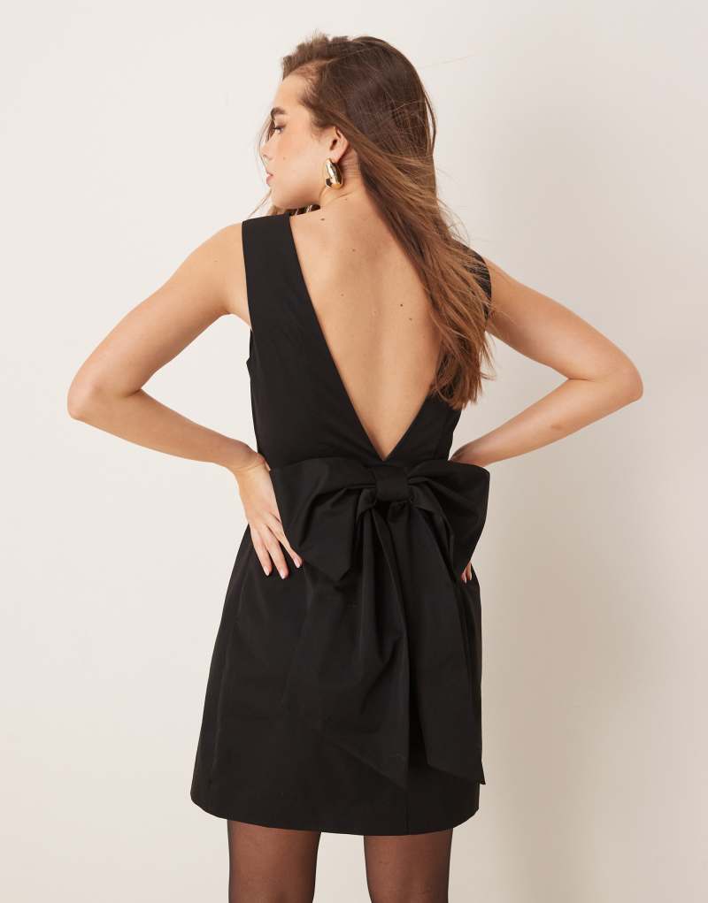 Gina Tricot mini dress with low v back and oversized bow detail at back in black GINA TRICOT