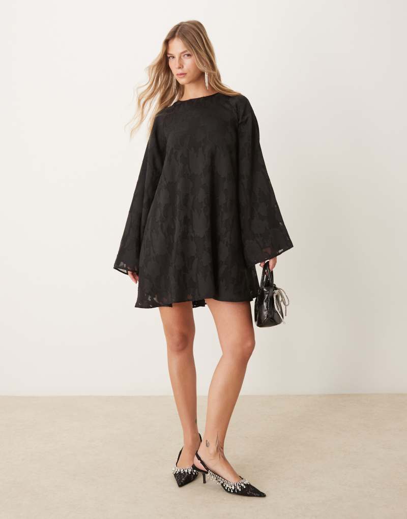 Gina Tricot jacquard sheer mini swing dress with satin bow back detail in black GINA TRICOT