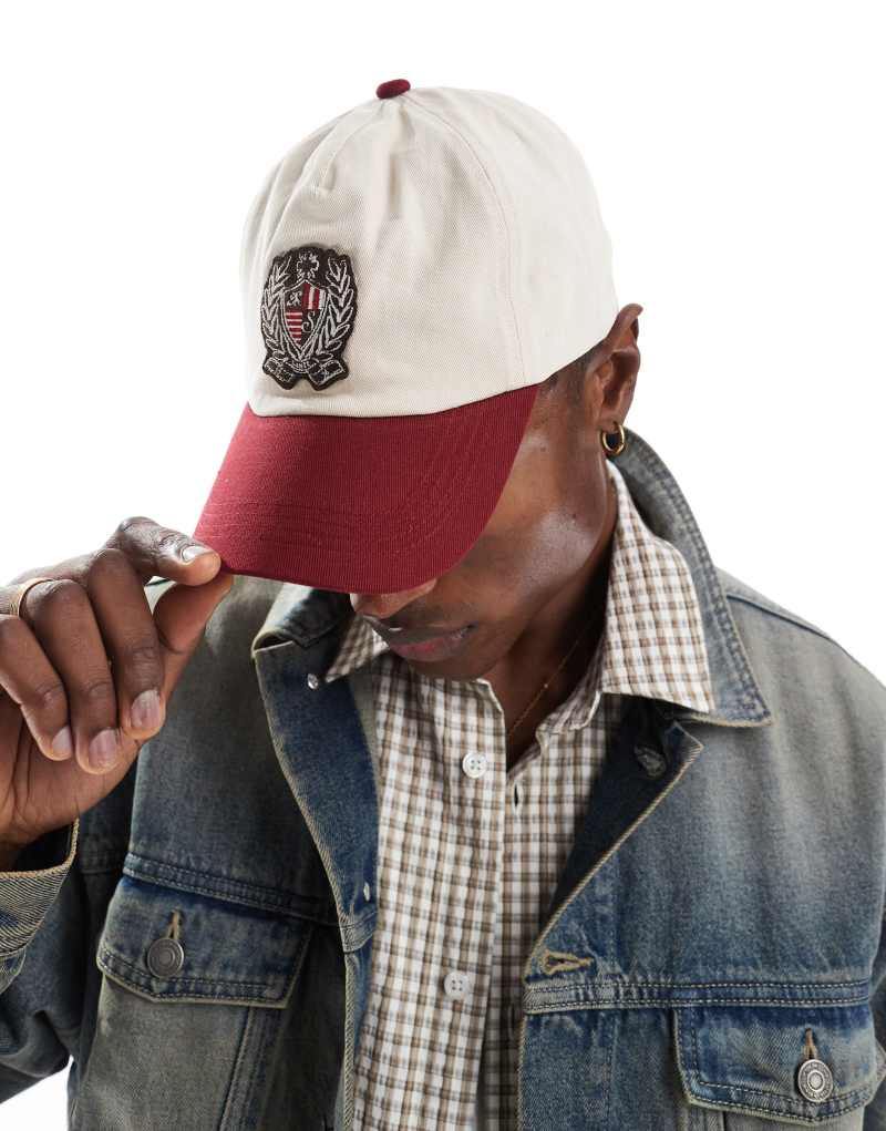 ASOS DESIGN vintage casual baseball cap in ecru with contrast burgundy peak and crest detail ASOS DESIGN