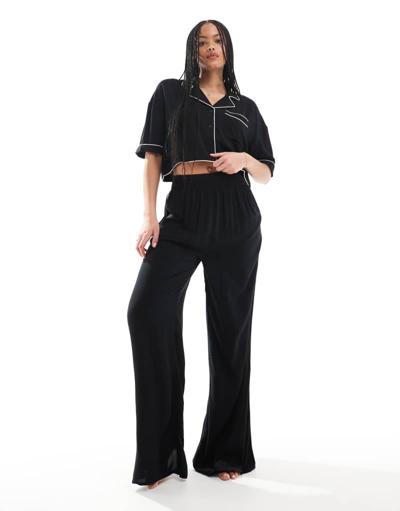 ASOS DESIGN Tall super soft slinky wide leg pajama pants in black with contrast binding ASOS Tall