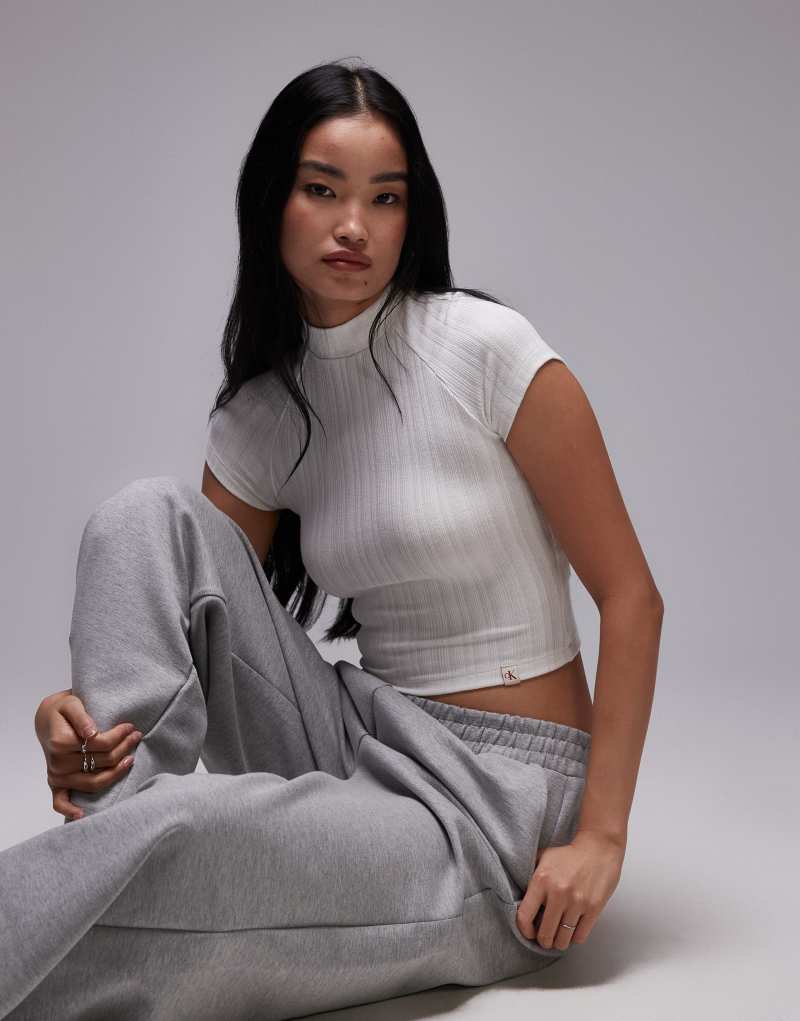 Calvin Klein Jeans high neck ribbed top in white Calvin Klein