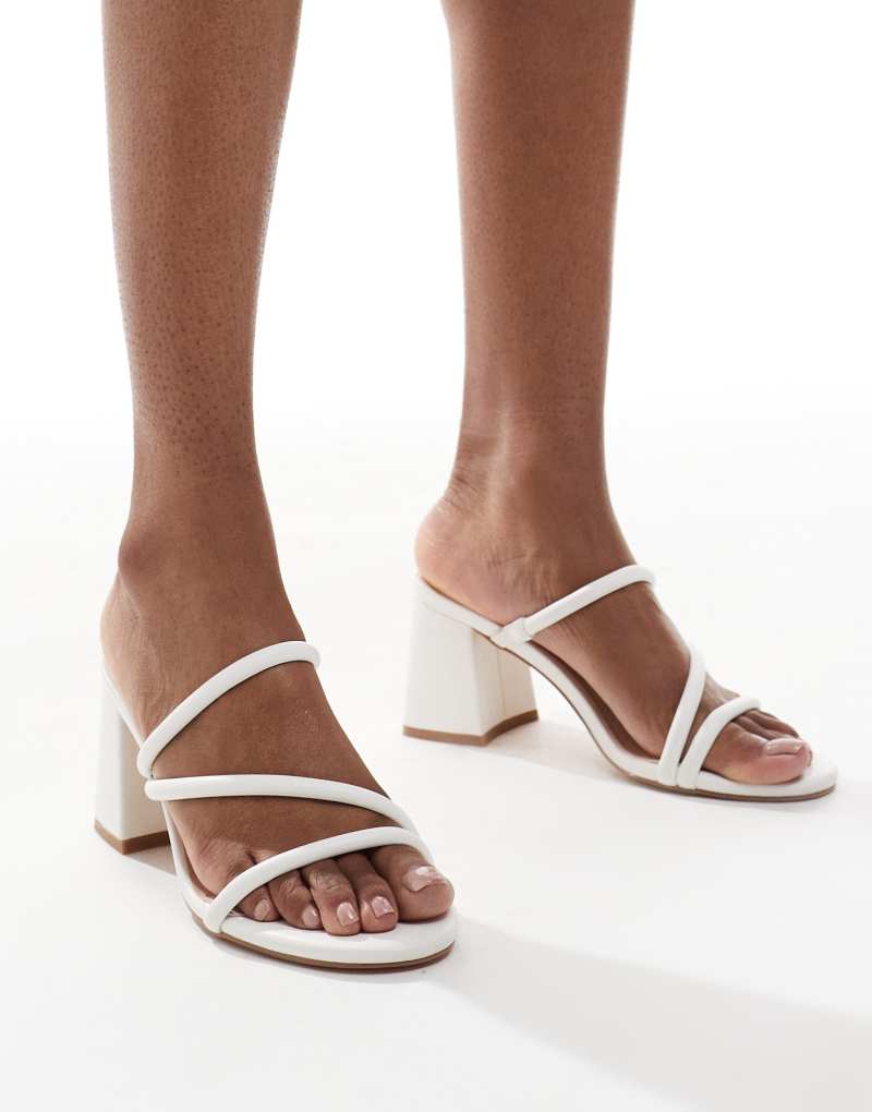 London Rebel Wide Fit strappy block heeled slip on sandals in white London Rebel