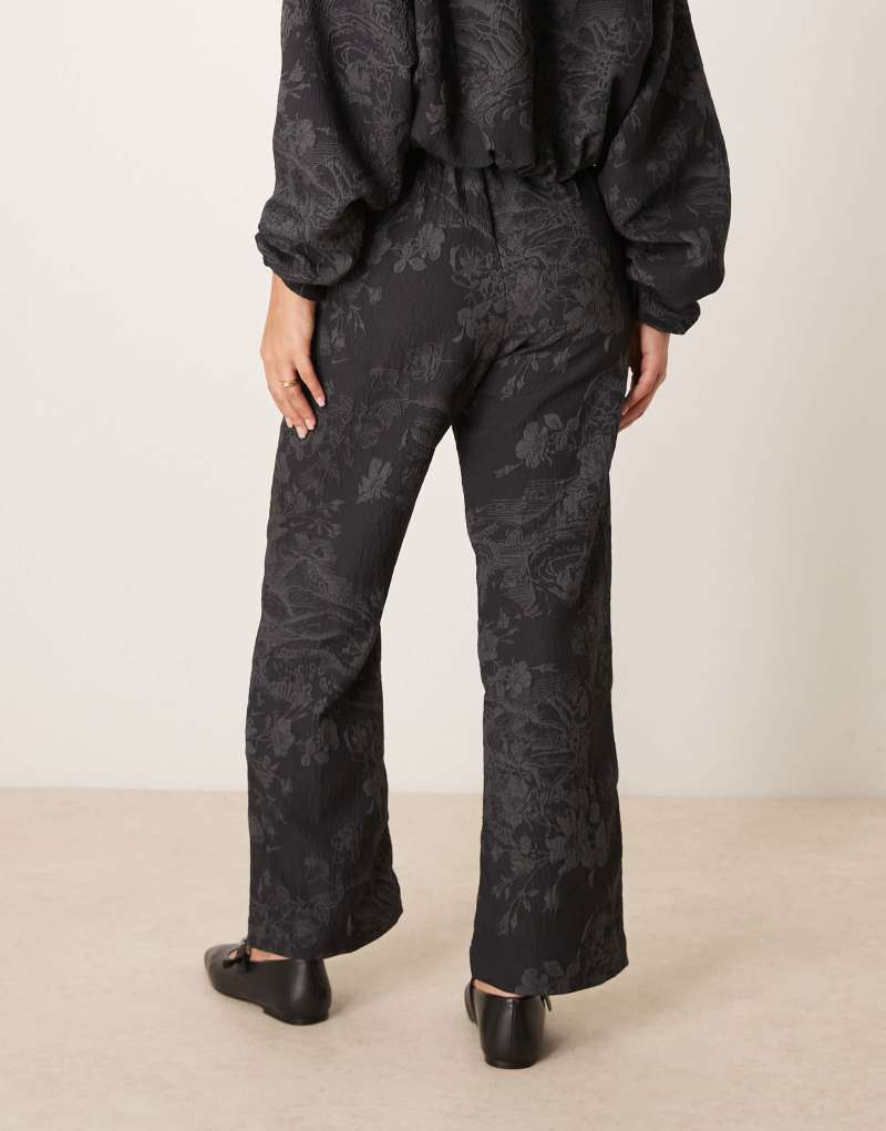 Nike flared jacquard print pants in black Nike