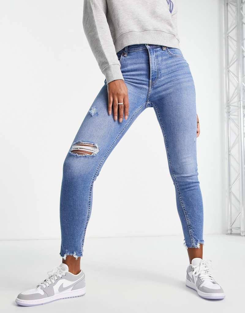 Bershka low waist skinny jean with rips in medium blue Bershka